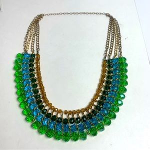 Green and blue beaded necklace with gold tone hardware.
